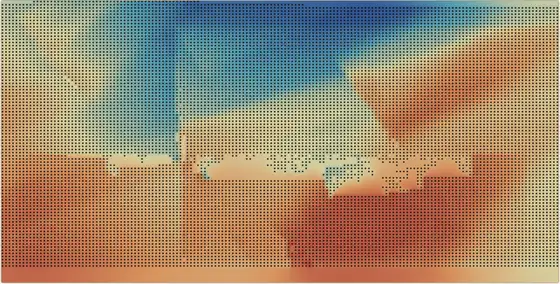A time-structure map of a horizon, filling the frame in blues through to reds, densely stippled with the dark dots of individual picks. A sharp offset runs across it where a fault displaces the surface.